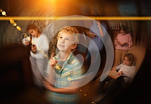 Thoughtful tween boy solving puzzle in escape room, toned image