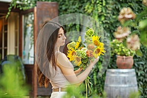 Thoughtful Woman Admiring a Bouquet of Sunflowers