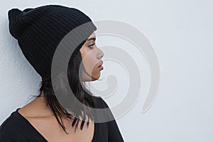 Thoughtful woman against white wall