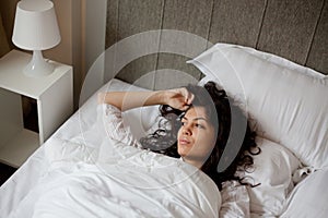 Thoughtful woman in bed photo