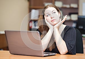 Thoughtful woman a brunette thinking at table