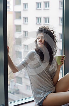 Thoughtful woman in the city apartment