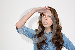 Thoughtful woman with hand at her forehead looking far away