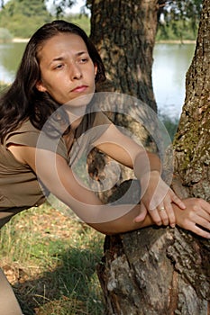 Thoughtful woman by lake