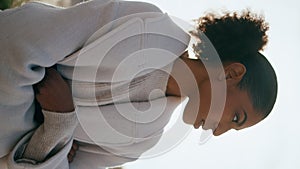 Thoughtful woman look distance rest on beach vertical. Worried black hair girl