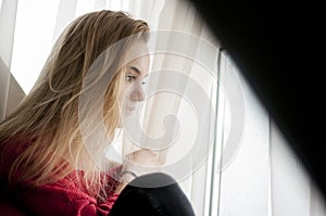 Thoughtful woman looking out window