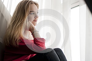 Thoughtful woman looking out window