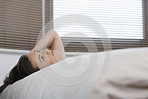 Thoughtful Woman Lying In Bed