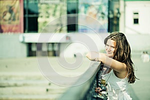 Thoughtful woman near fence