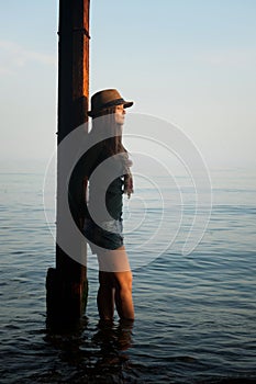 Thoughtful woman portrait on a sea beach mooring