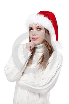 Thoughtful woman in a Santa hat isolated on white background