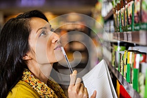 Thoughtful woman shopping for grocery