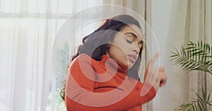 Thoughtful woman sitting on sofa working on her laptop at home 4K 4k