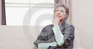 Thoughtful woman thinking with hand on chin