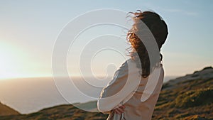 Thoughtful woman watching sunset on ocean mountain. Worried girl contemplating