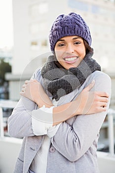 Thoughtful woman in winter coat trembling