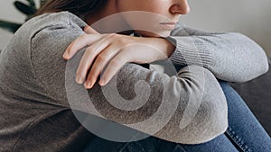 Thoughtful worried caucasian female suffering depression feeling lonely, alone at home. Close up of depressed sad young woman