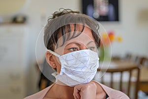 Thoughtful worried woman wearing a face mask