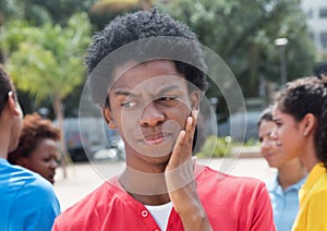 Thoughtful young african american man with friends