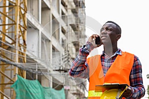 Thoughtful young black African man construction worker talking o
