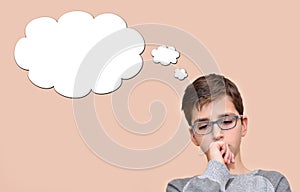 Thoughtful young boy with an empty thought bubble