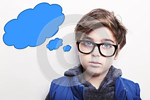 Thoughtful boy wearing glasses with an empty thought bubble