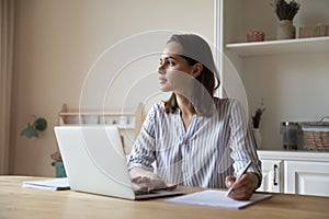 Thoughtful young business professional lost in deep thoughts at workplace