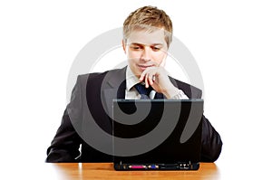 Thoughtful young businessman behind the computer