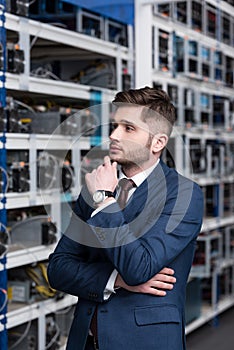 thoughtful young businessman with hand on chin at ethereum