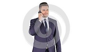 Thoughtful young businessman in suit and tie making several calls quickly on white background.