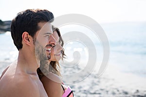 Thoughtful young couple standing at beach