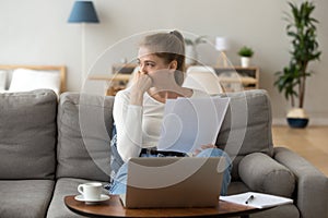 Thoughtful young female distracted from studying looking away