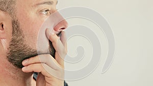 a thoughtful young man, close-up on a white background