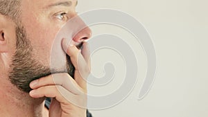 a thoughtful young man, close-up on a white background