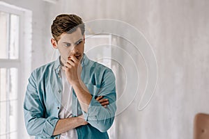 Thoughtful young man wearing lounge wear clothes