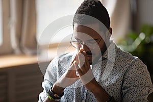 Thoughtful young mixed race man feeling complicated about hard decision.