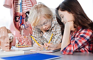 Thoughtful young students making notes