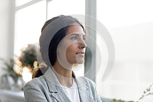 Thoughtful young woman look in distance visualizing