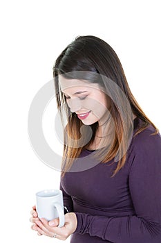 Thoughtful young woman smelling the aroma of coffee drink in mug cup