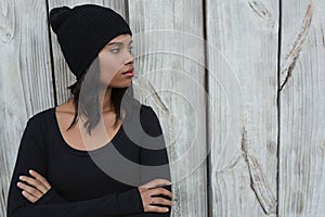 Thoughtful young woman standing with arms crossed