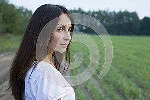 Thoughtful Young Woman Standing In Field