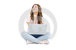 Thoughtful young woman using laptop