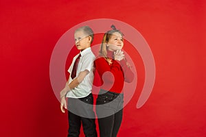 Valentine`s day celebration, happy caucasian kids isolated on red background