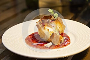 A thousand sheets of brie cheese with red fruit jam