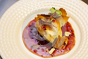 A thousand sheets of brie cheese with red fruit jam