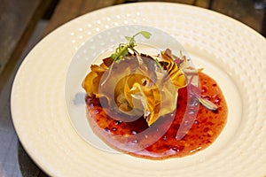 A thousand sheets of brie cheese with red fruit jam