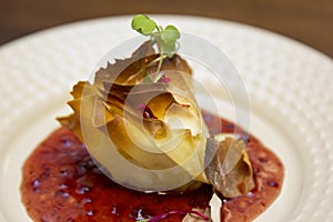 A thousand sheets of brie cheese with red fruit jam