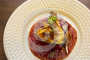 A thousand sheets of brie cheese with red fruit jam