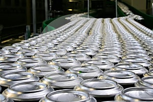 Thousands of beverage aluminum cans on conveyor line at factory photo