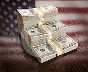 Thousands of Dollars with Reflection of American Flag on Table